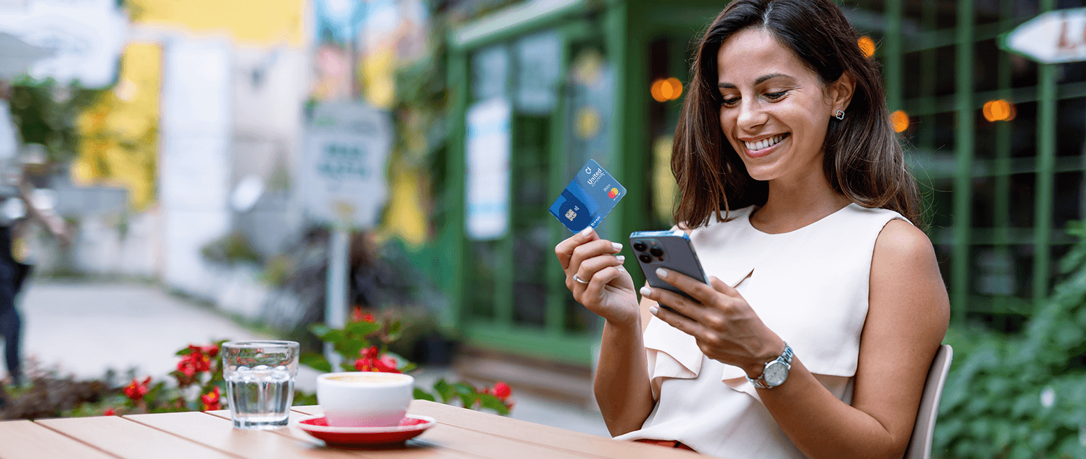 Woman banking on phone holding debit card