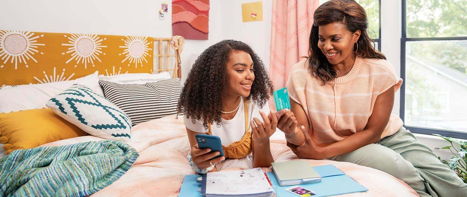 mom teaching daughter Greenlight budgeting and spending