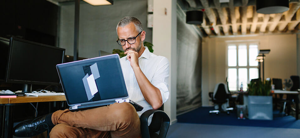 Man using laptop in an office