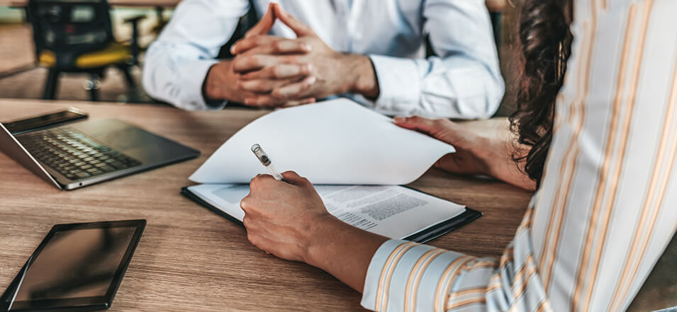 person signing a business loan application