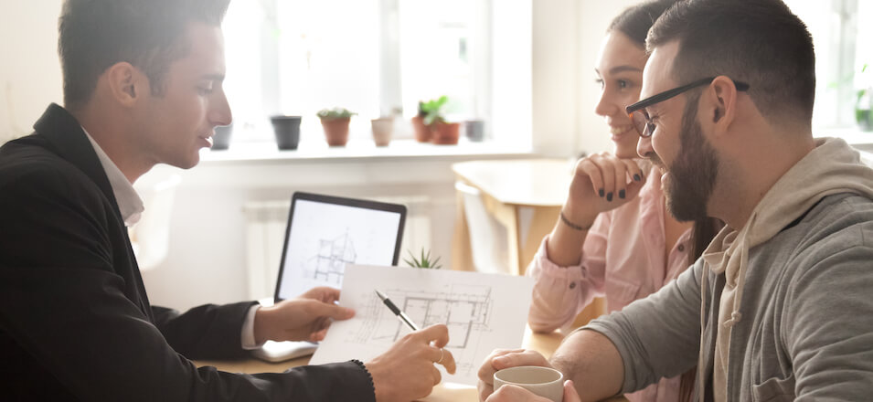 couple working with architect on home build plans