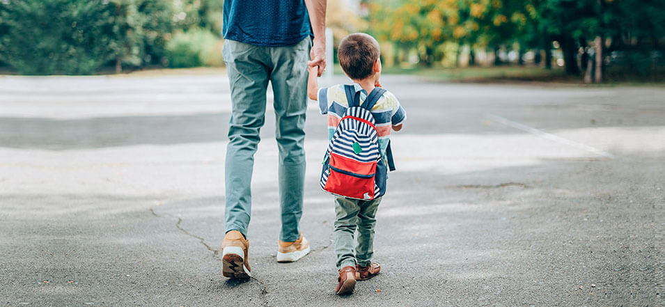 Child walking with his father