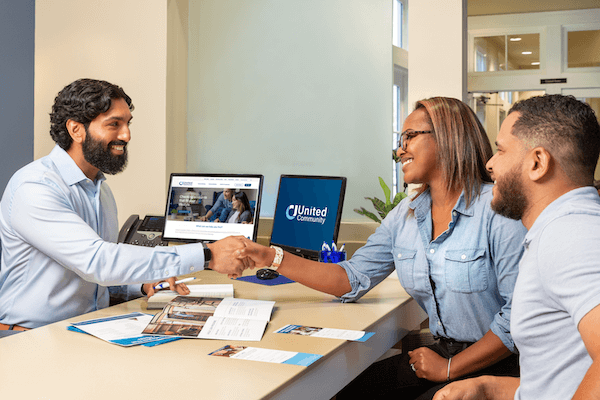 couple speaking with a community banker 