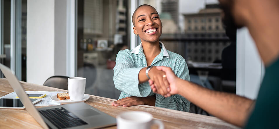 Female mortgage loan originator shaking a clients hand