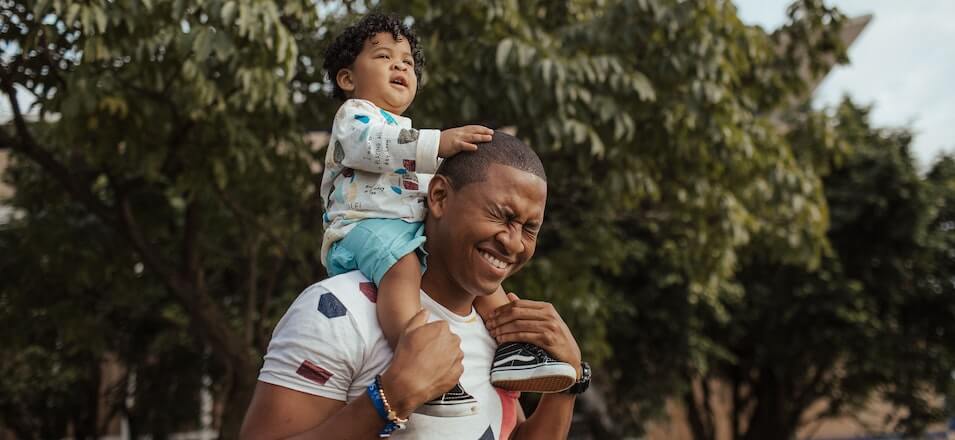 Man carrying child on his shoulders