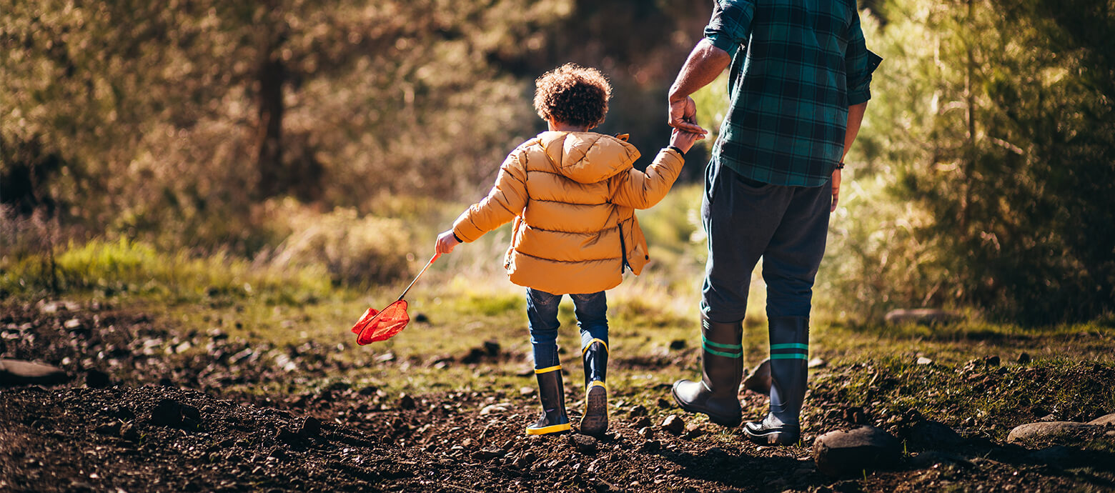 son and father walking through nature