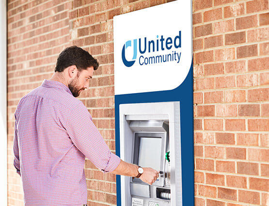 man at a United ATM with new United Community logo