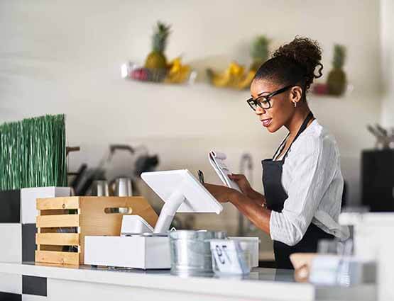 woman using POS system for small business