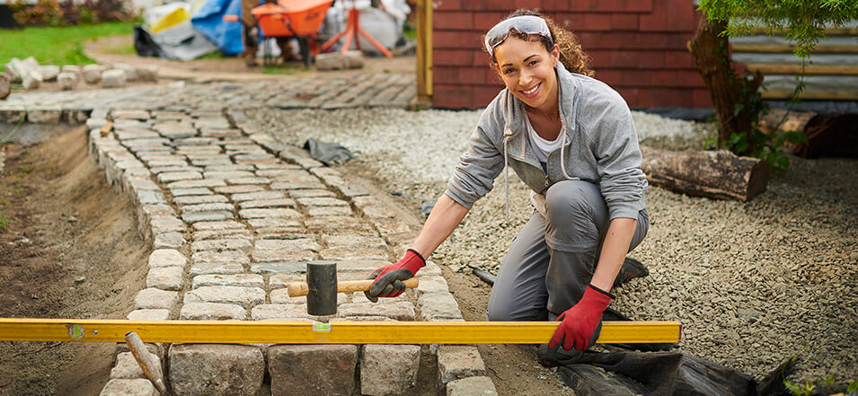 woman building a side walk in her yard