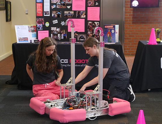 young girls building a robot
