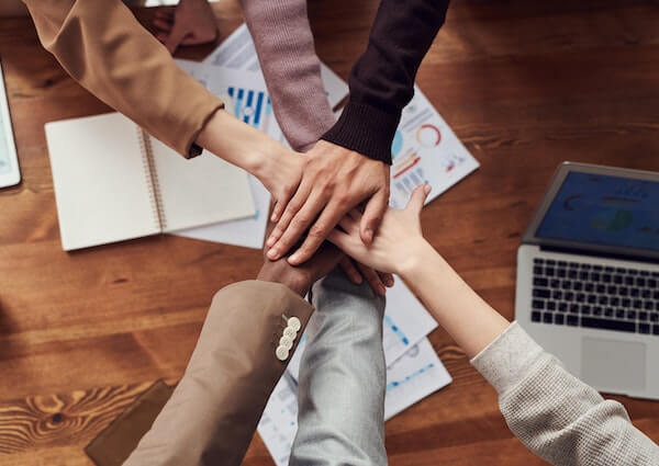 diverse team with hands in a huddle