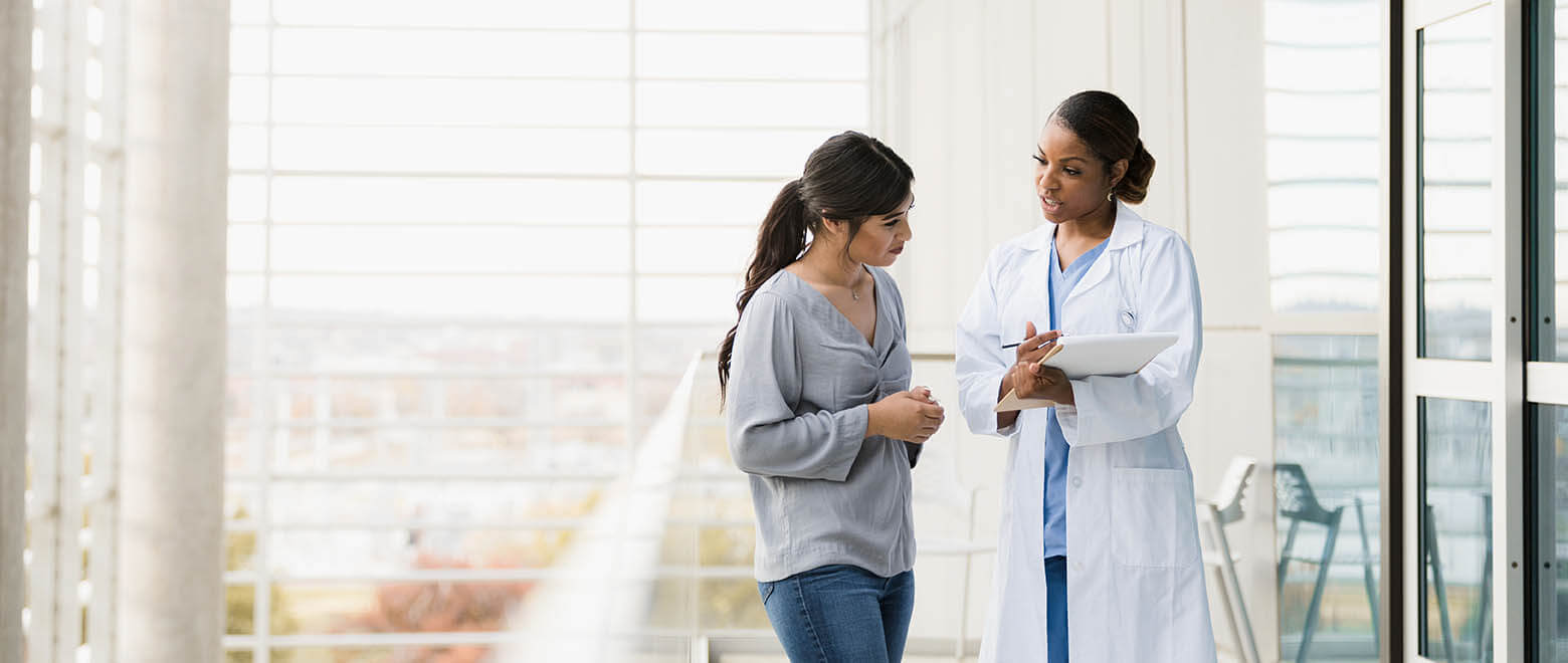 female doctor speaking with a patient about her healthcare