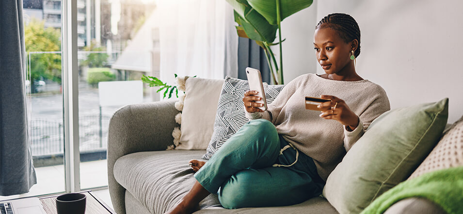 woman looking at her credit card activity on her phone