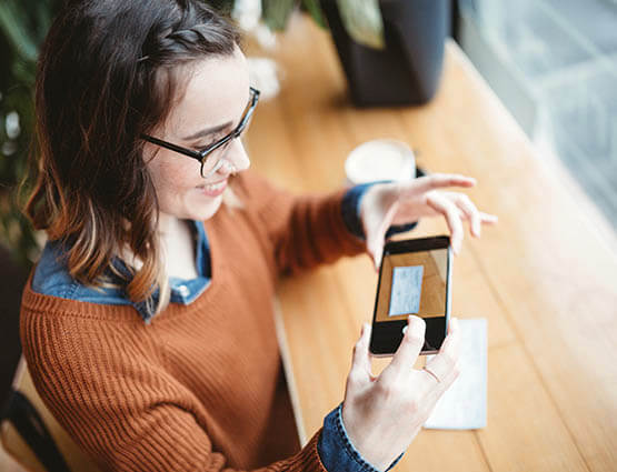 woman depositing a check on mobile device