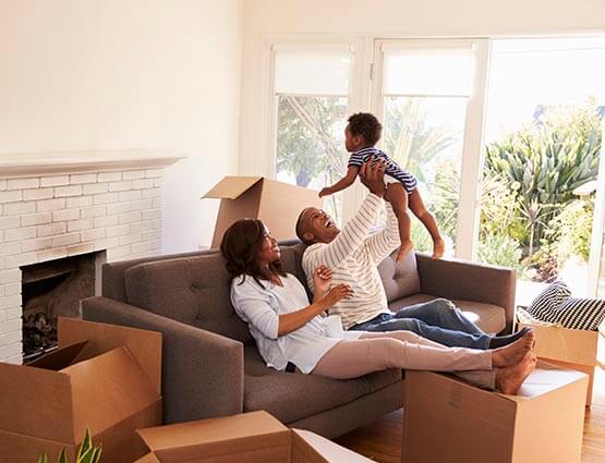 family unpacking boxes in their new home after using down payment assistance