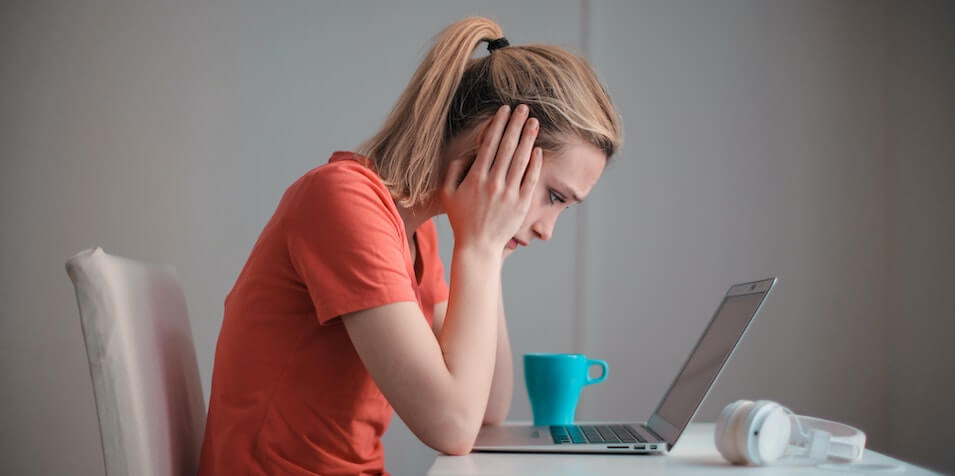 Troubled woman using laptop