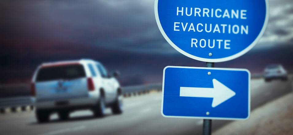 Car near "hurricane evacuation route" sign