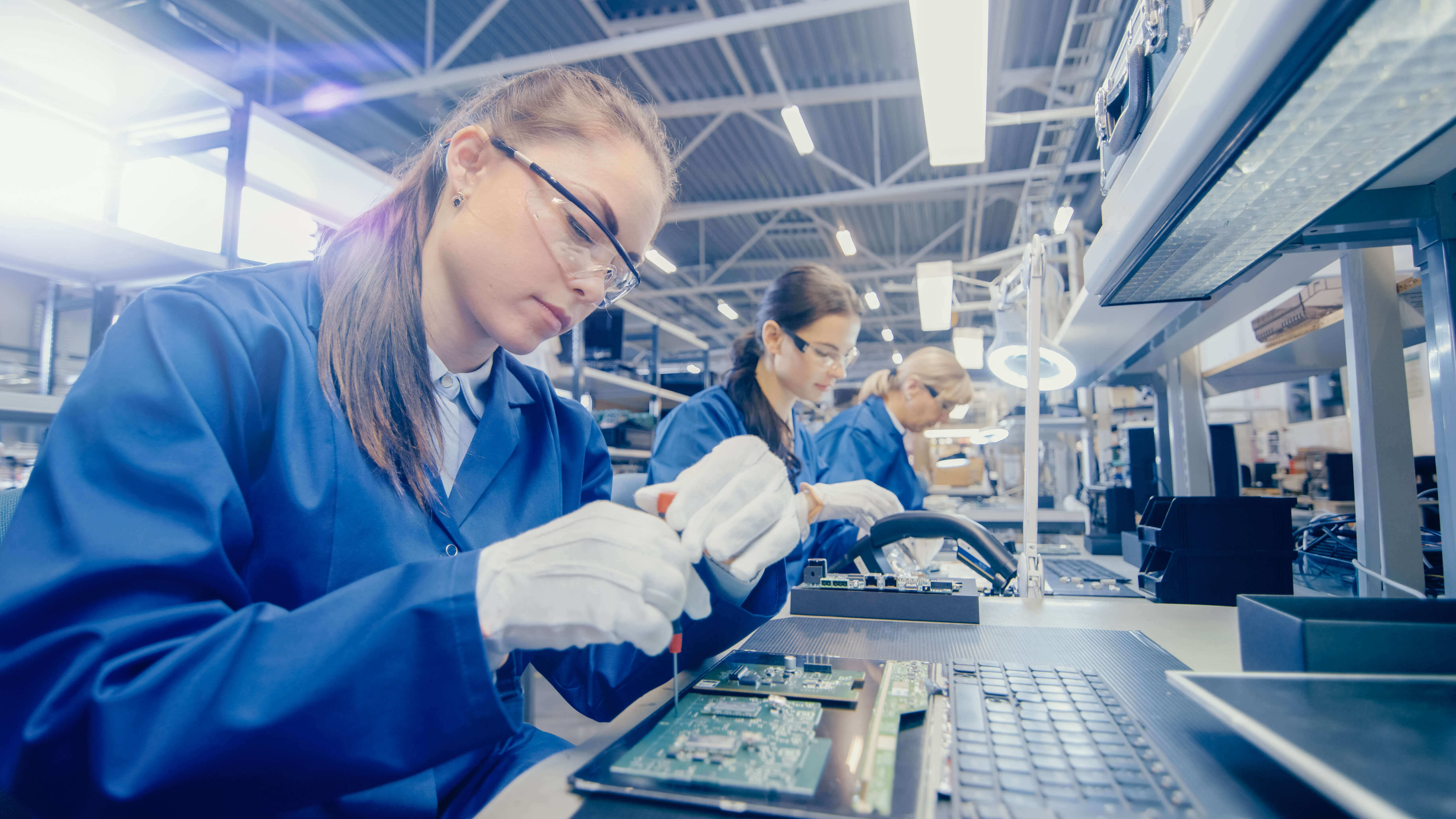 Employees working in a tech manufacturing plant 