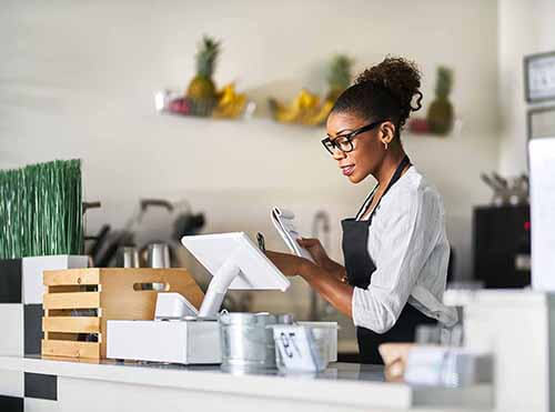 Woman using Clover merchant system