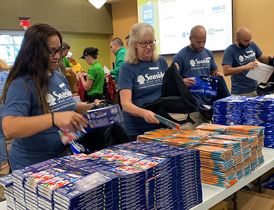 Seaside bankers volunteer in "The Big Backpack Build"