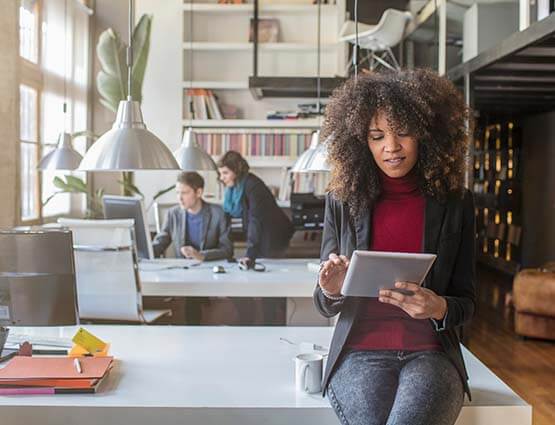 woman standing in business with tablet