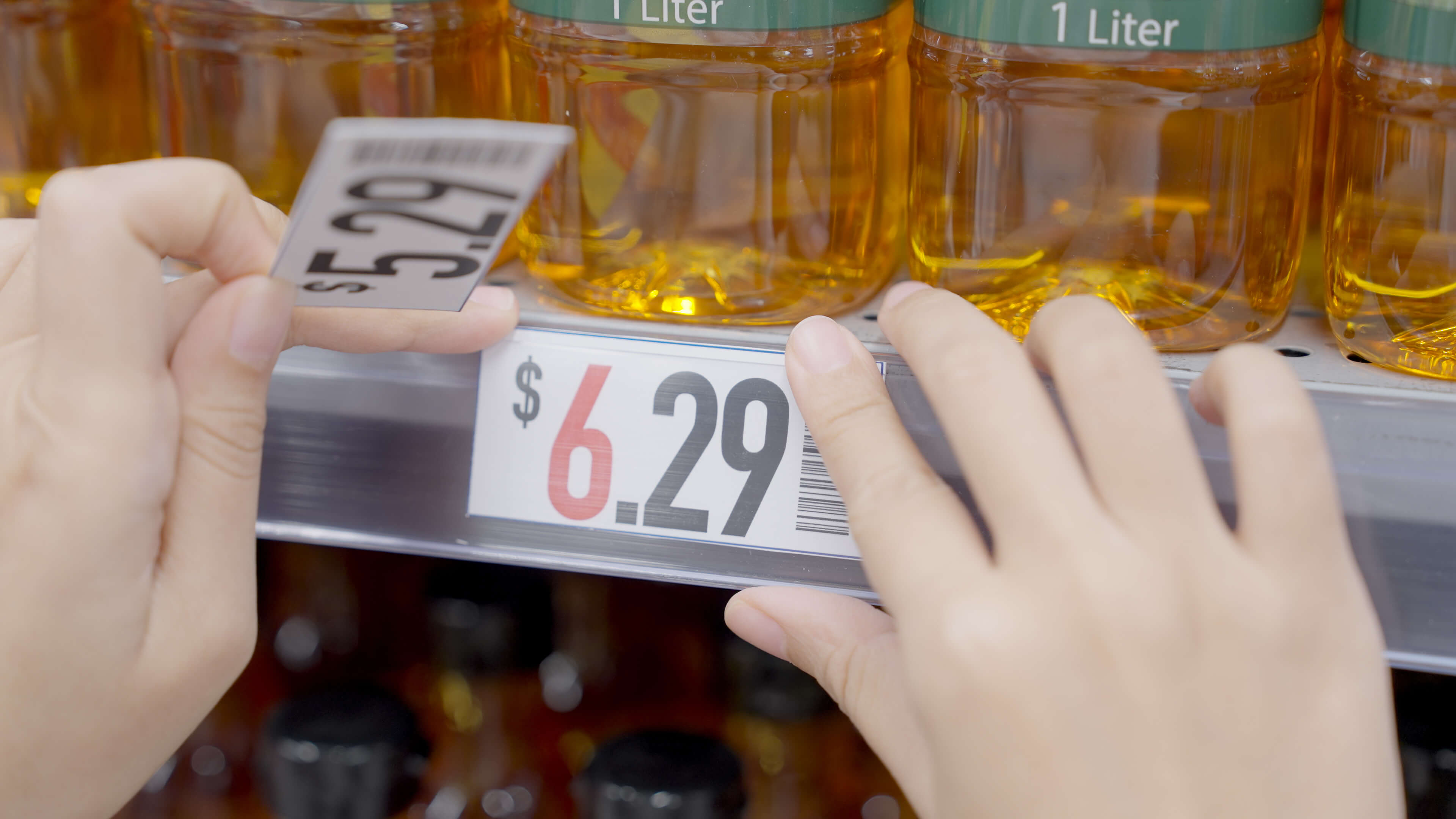 Grocery store shelf showing prices on goods being changed