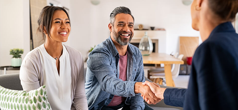 couple shaking hands with their mortgage lender