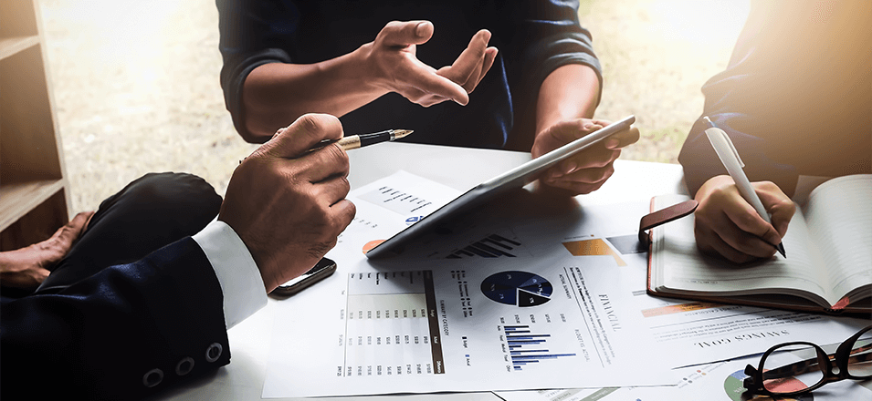 business people looking over financial documents and making notes