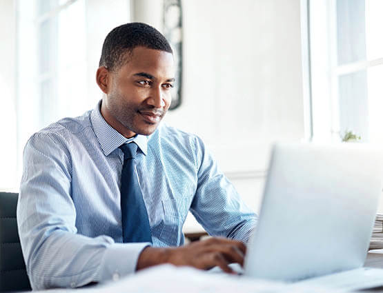 man on a laptop sending an ACH