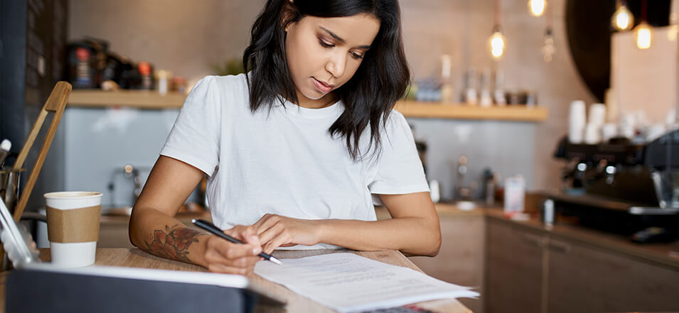 Woman budgeting for the year to avoid financial stress