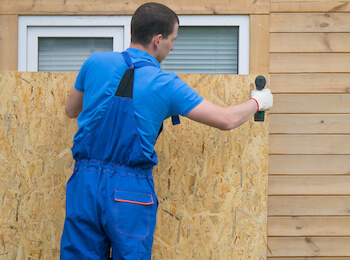Man boarding up windows