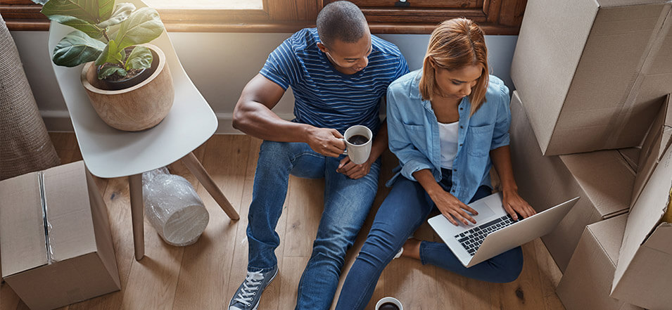 Couple looking at computer while moving