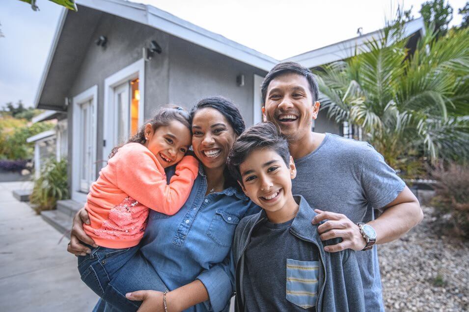 happy family in front of their home