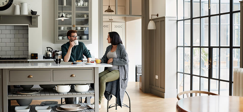 Couple talking at kitchen table