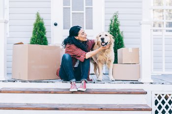 woman moving and petting dog