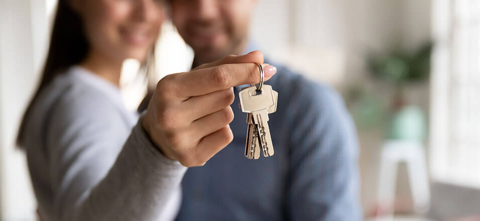 Couple holding keys to a new home