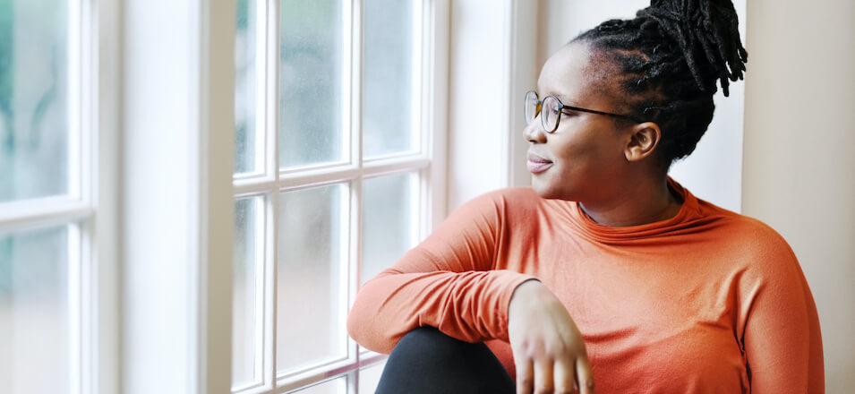 Woman sitting staring out window