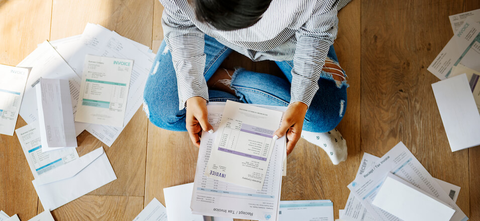 woman surrounded by bills