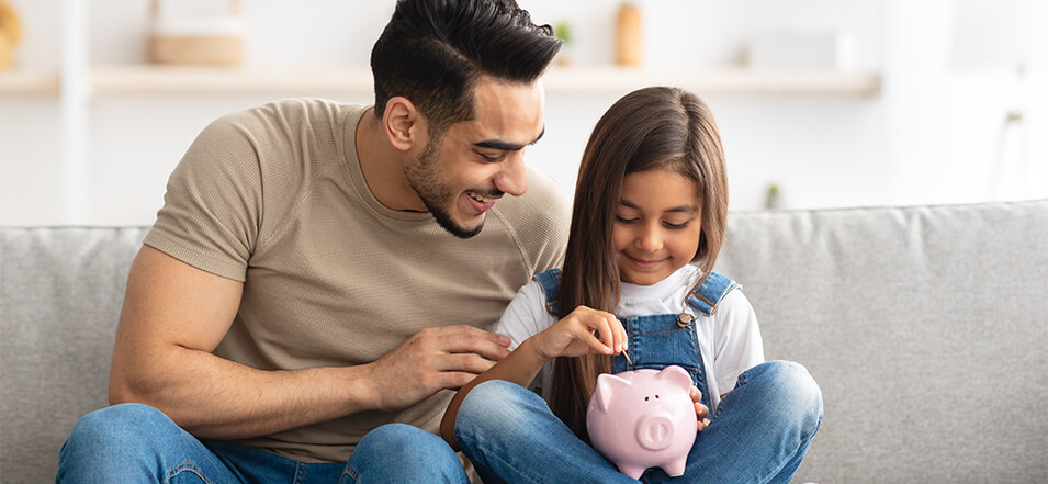 father teaching daughter savings tips